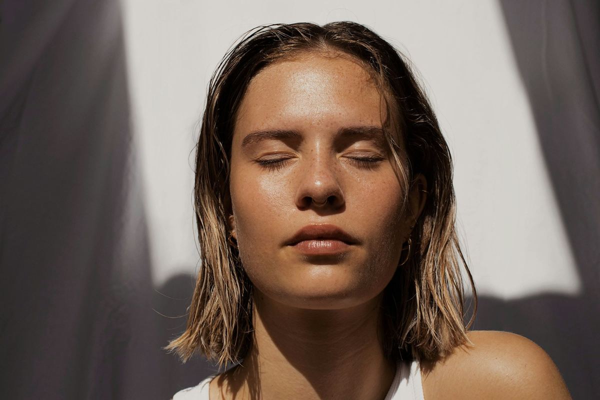 Woman resting peacefully in soft daylight, representing confidence and bladder control support